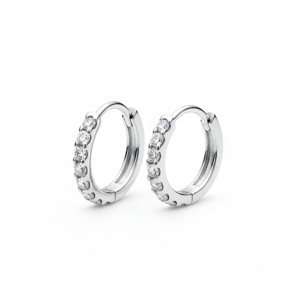 Pair of silver hoop earrings with small diamonds on a white background