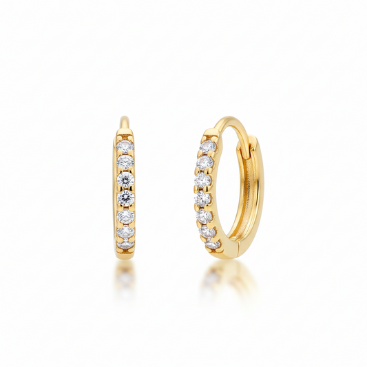 Gold hoop earrings with embedded diamonds on a white background