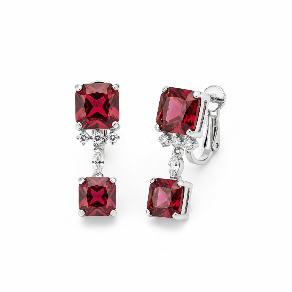 Pair of earrings with red gemstones on a white background