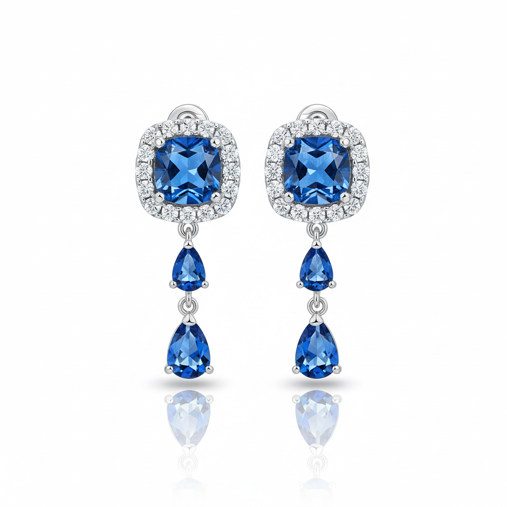 Pair of blue gemstone earrings with silver accents on a white background