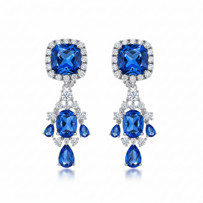 Pair of blue gemstone earrings with silver accents on a white background
