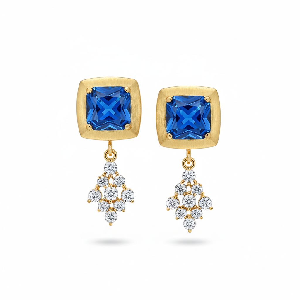 Gold earrings with blue gemstones and diamond-like elements on a white background