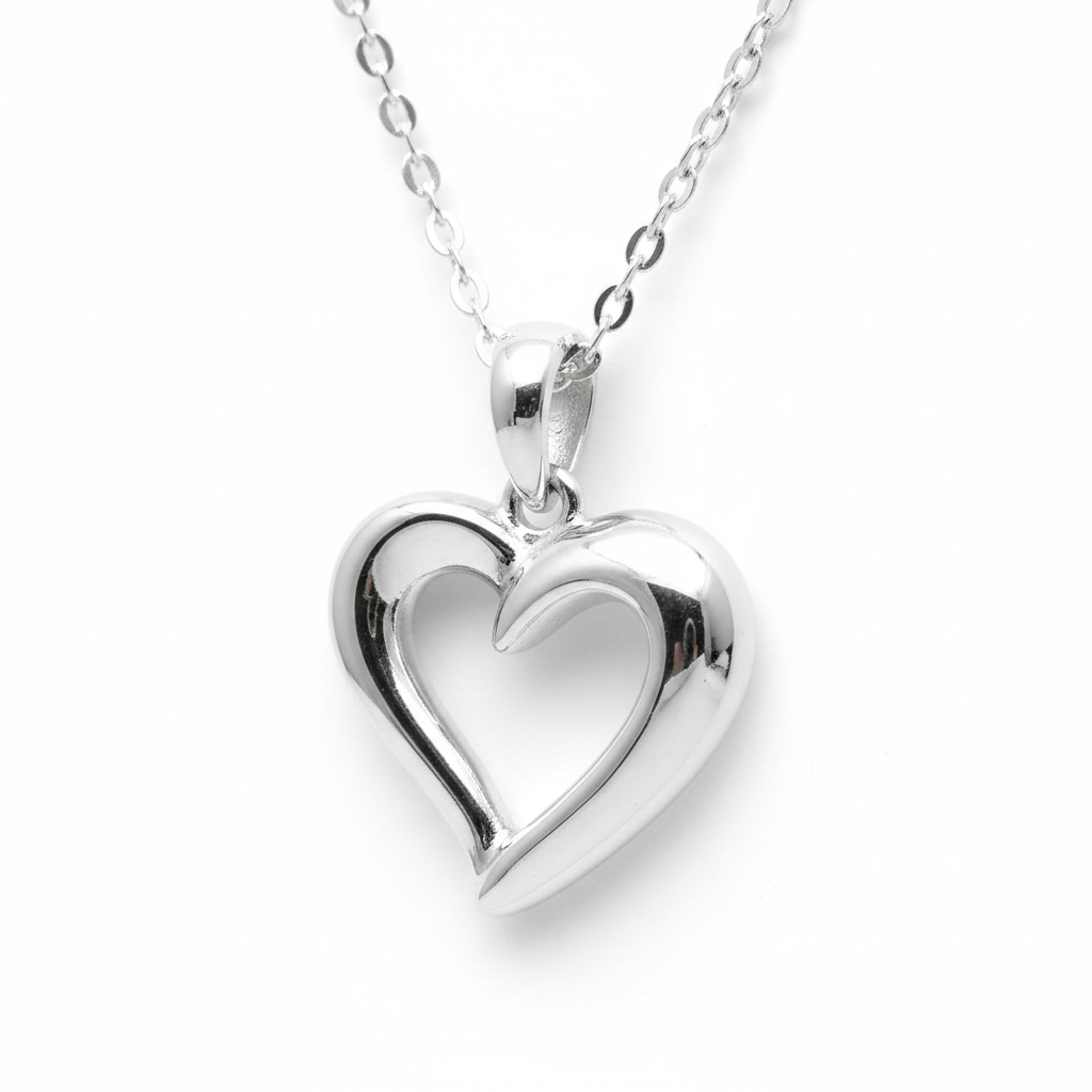 Silver heart-shaped pendant on a chain against a white background