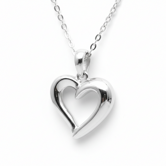 Silver heart-shaped pendant on a chain against a white background